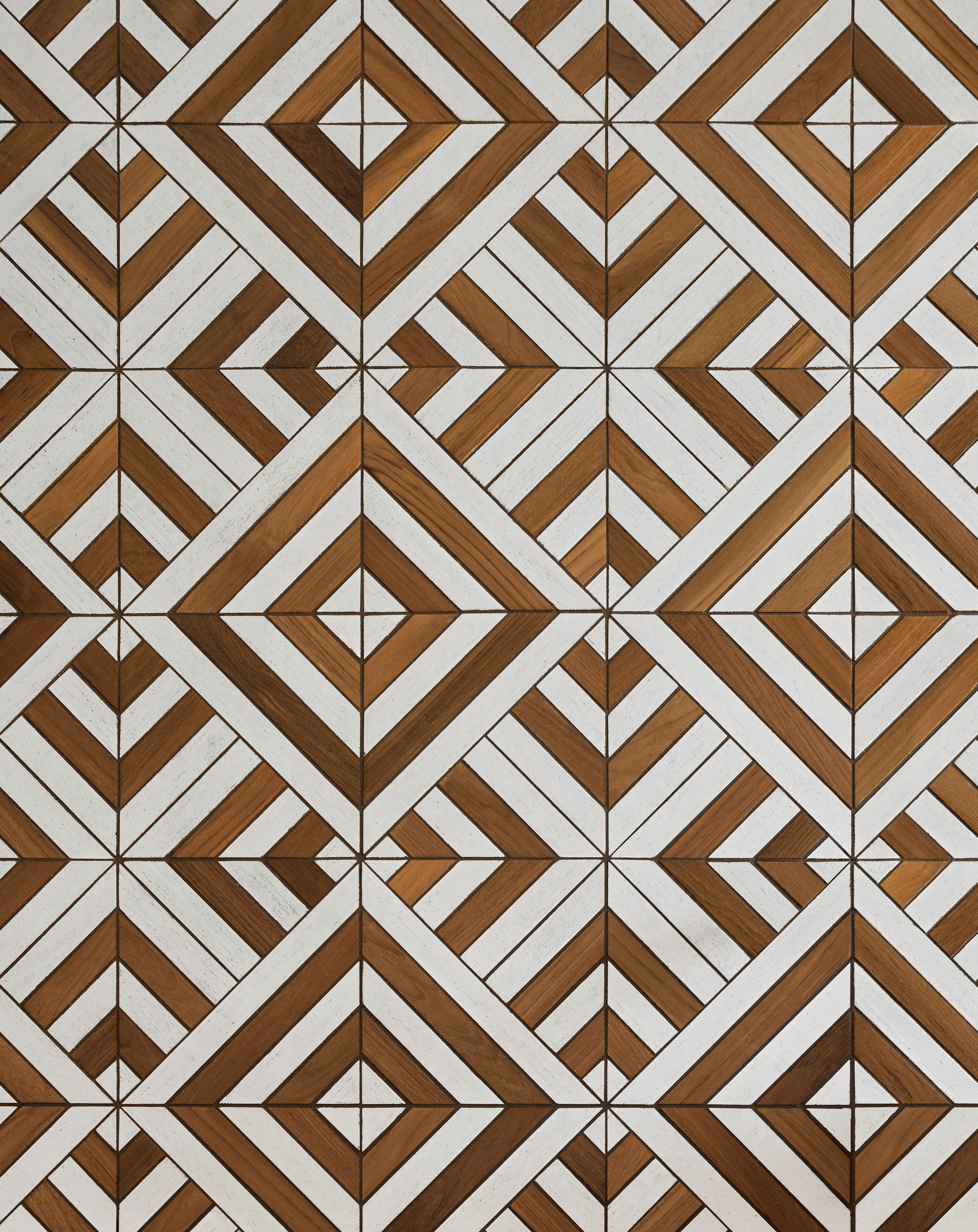 Close up of the patterned teak and white floor tile in the entry.