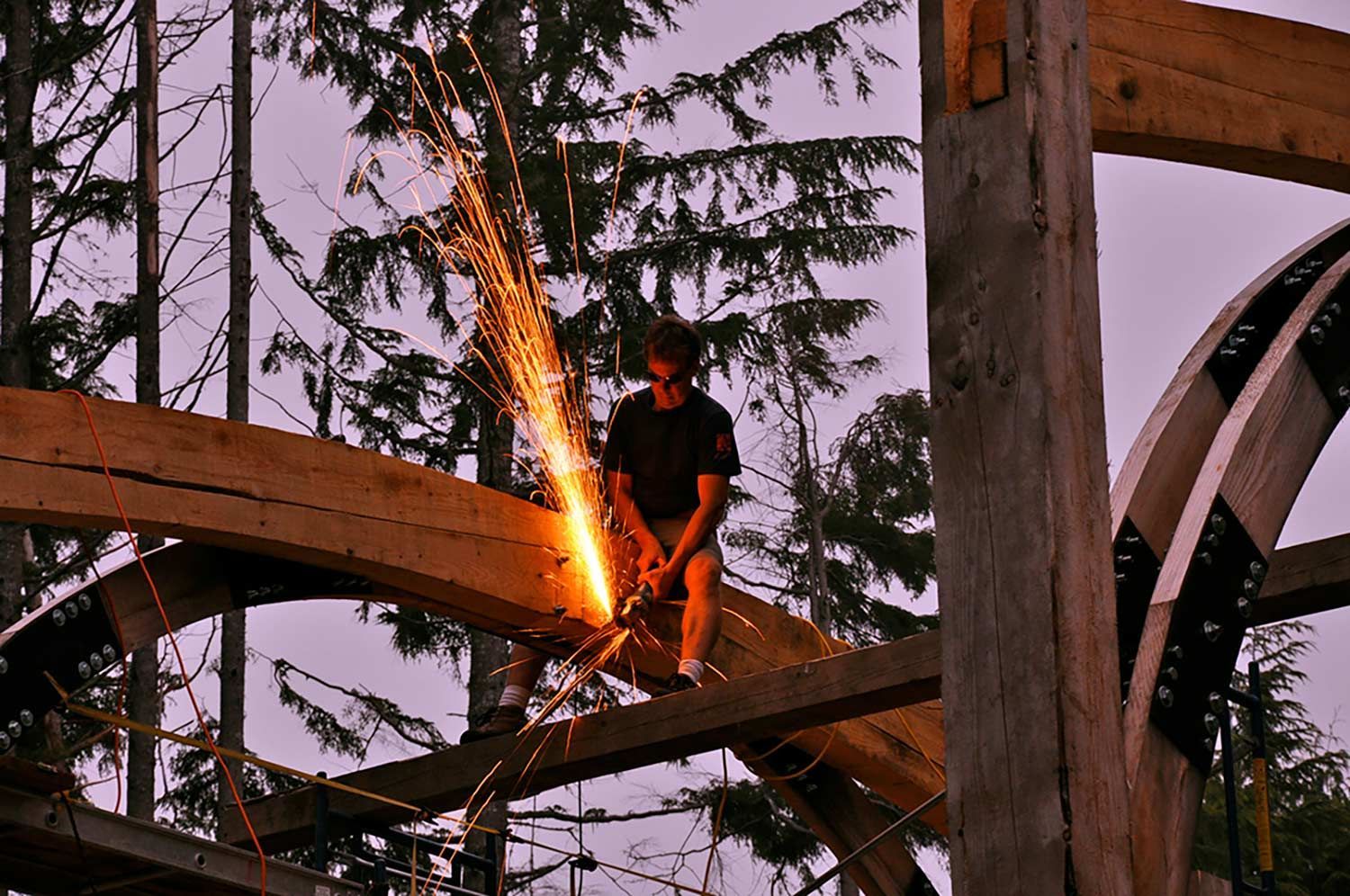A man is cutting a piece of wood with a grinder