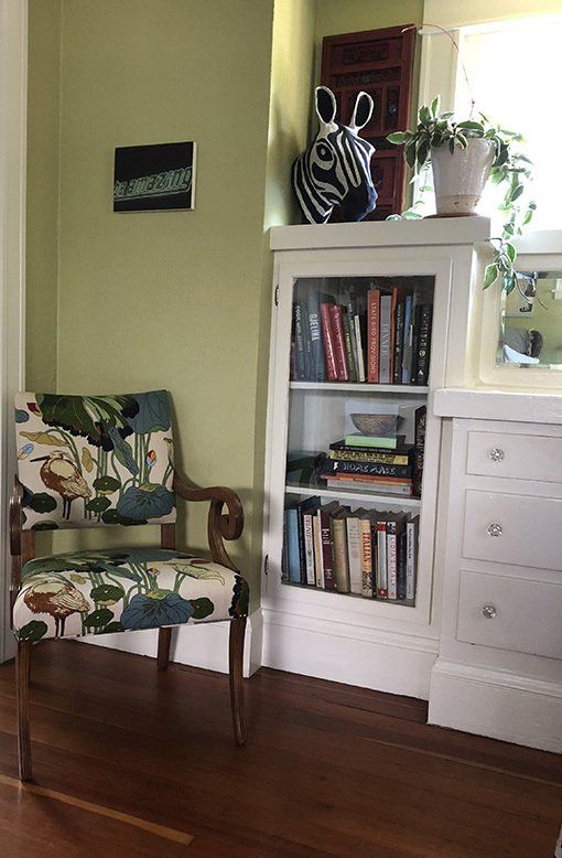 Kerri found this vintage chair at a local vintage store and had it recovered by favorite upholsterer, Lake Grove Upholstery; antique screen from China; a quirky zebra head that gets dressed up for every holiday and a “Be Amazing” print bought at a street market in London. You can also see a portion of Kerri’s huge collection of cookbooks.