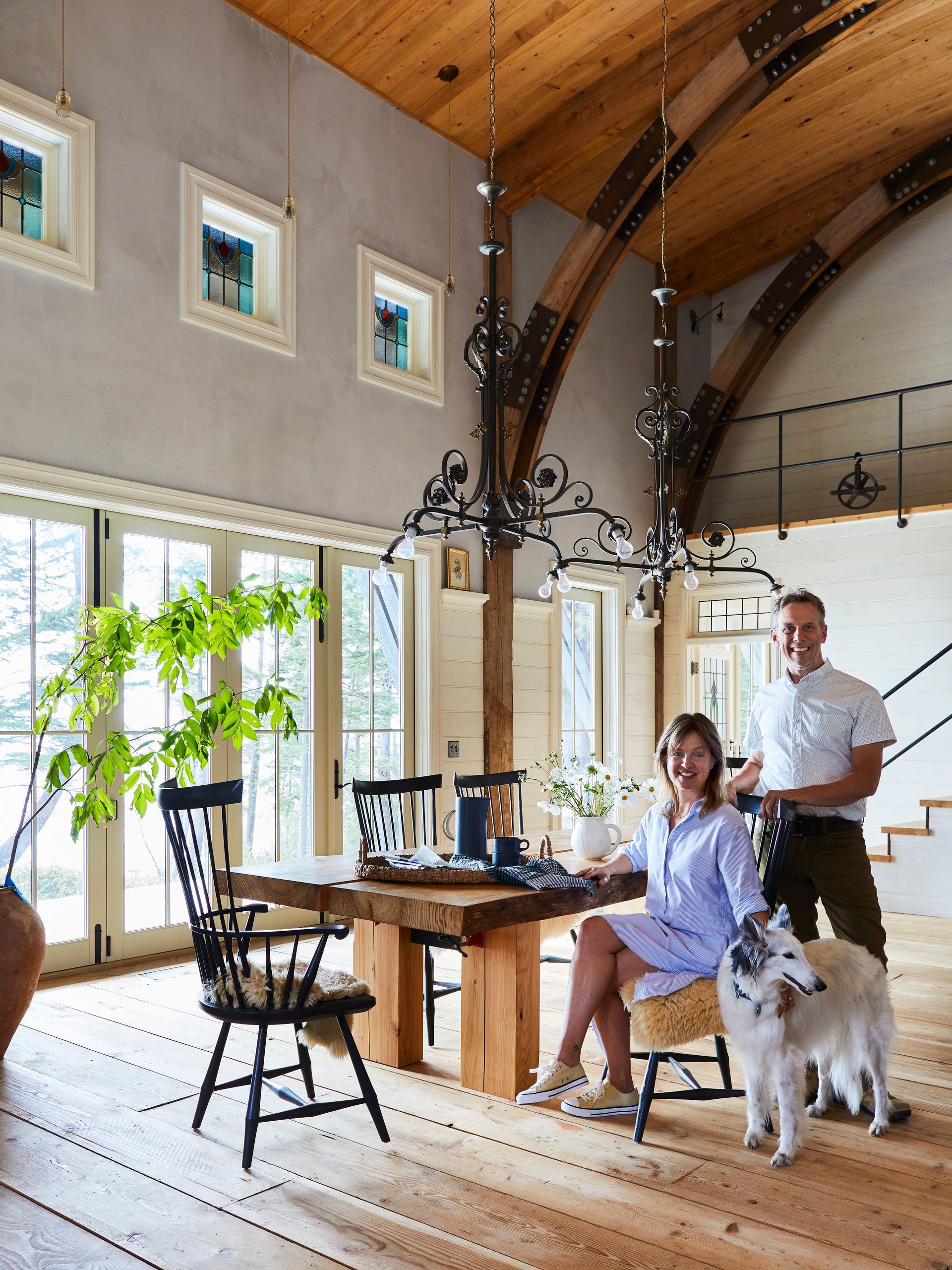 Anne and Richard De Wolf with silken windhound Finney in the coastal home they built for themselves.