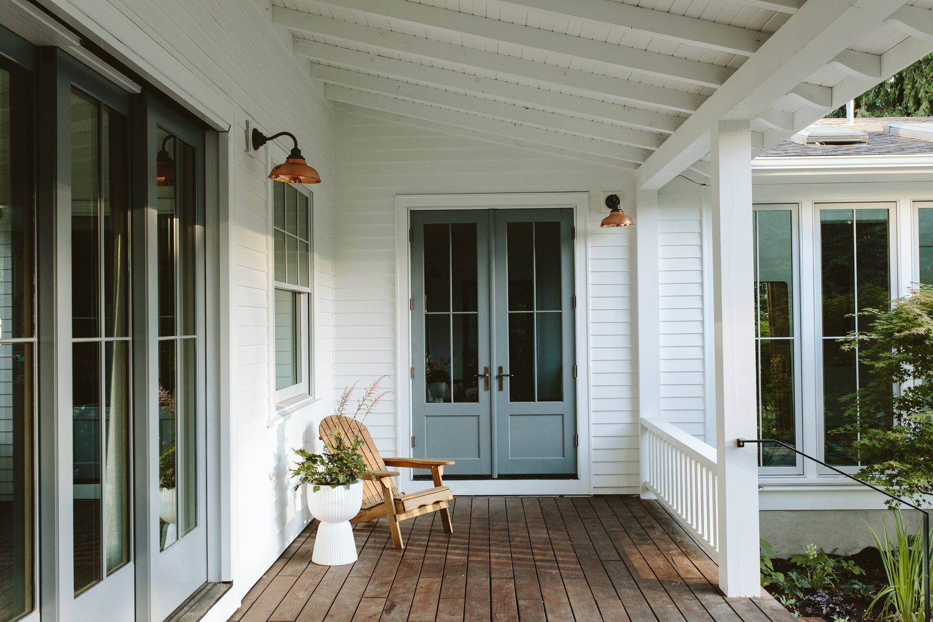 Porch addition with a vaulted ceiling, a large accordion door, a double door, and Sapele decking.