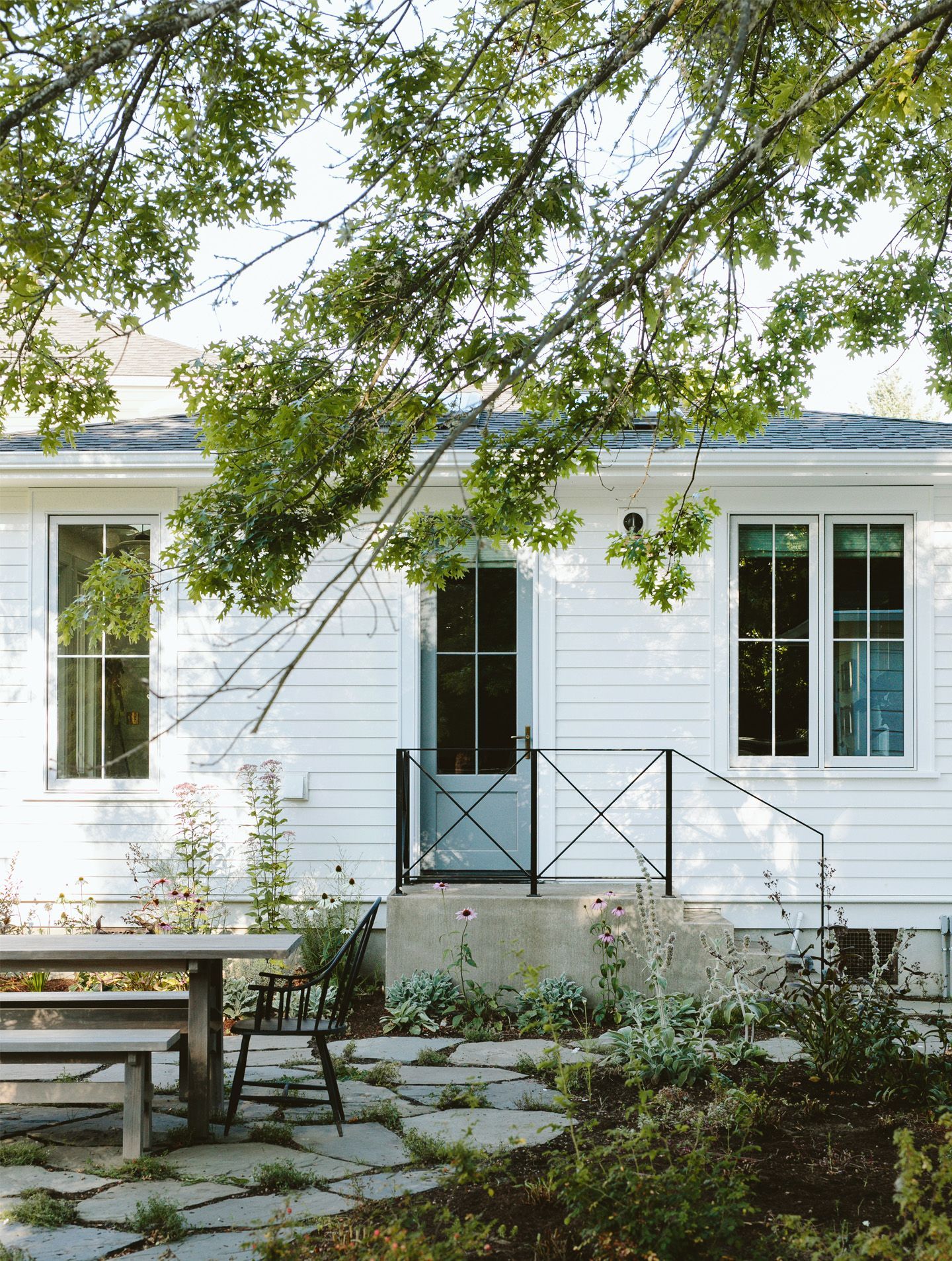 Remodeled addition from the 1960’s with classic metal guard rail, flagstone patio and picnic table and benches.