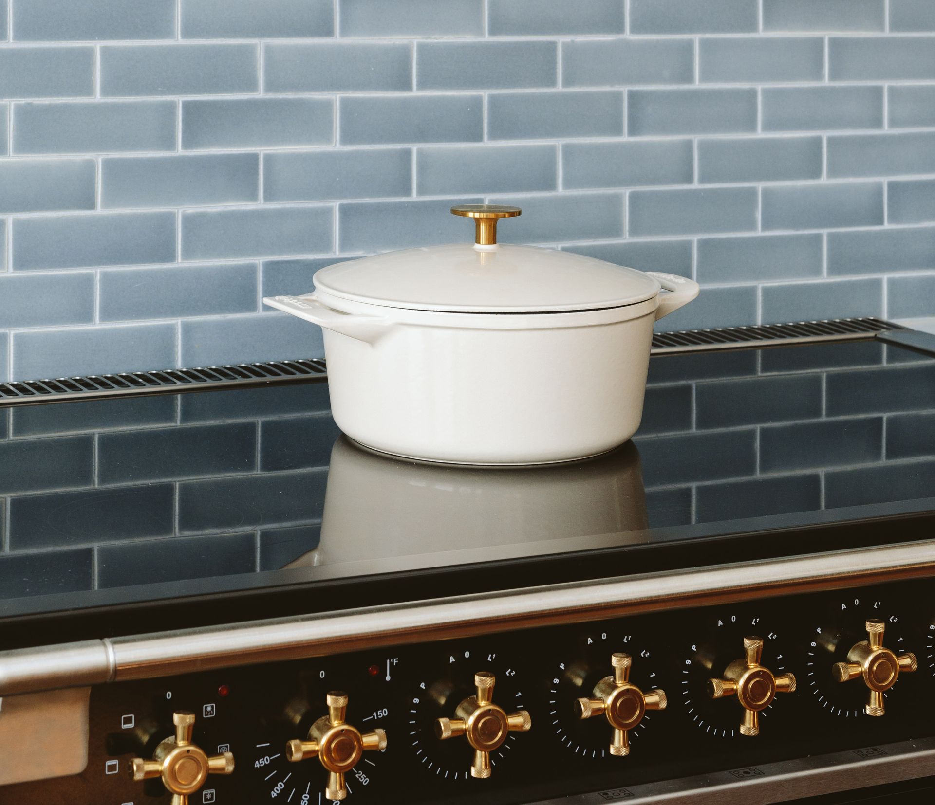 An AGA induction range with white Le Creuset pot. 
