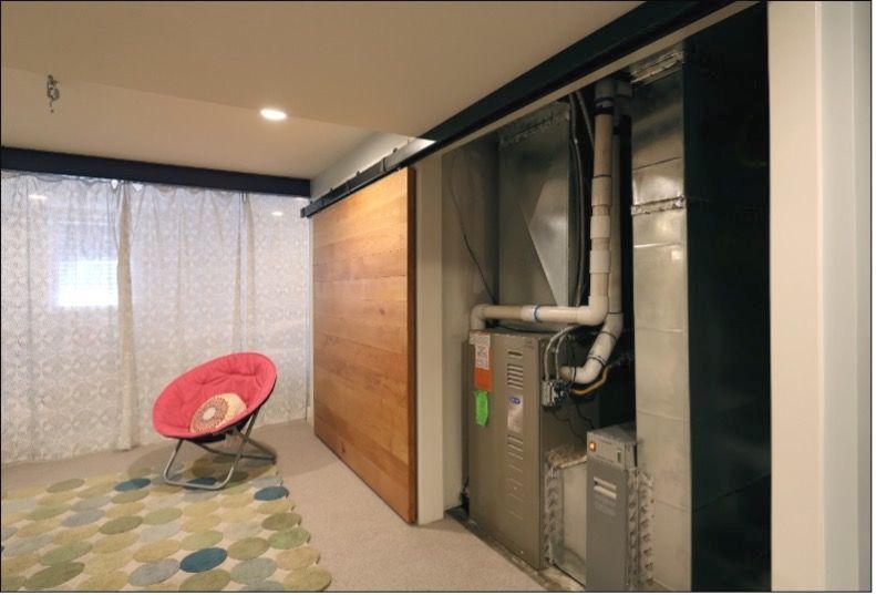 Picture of home systems being hidden behind a decorative basement wall