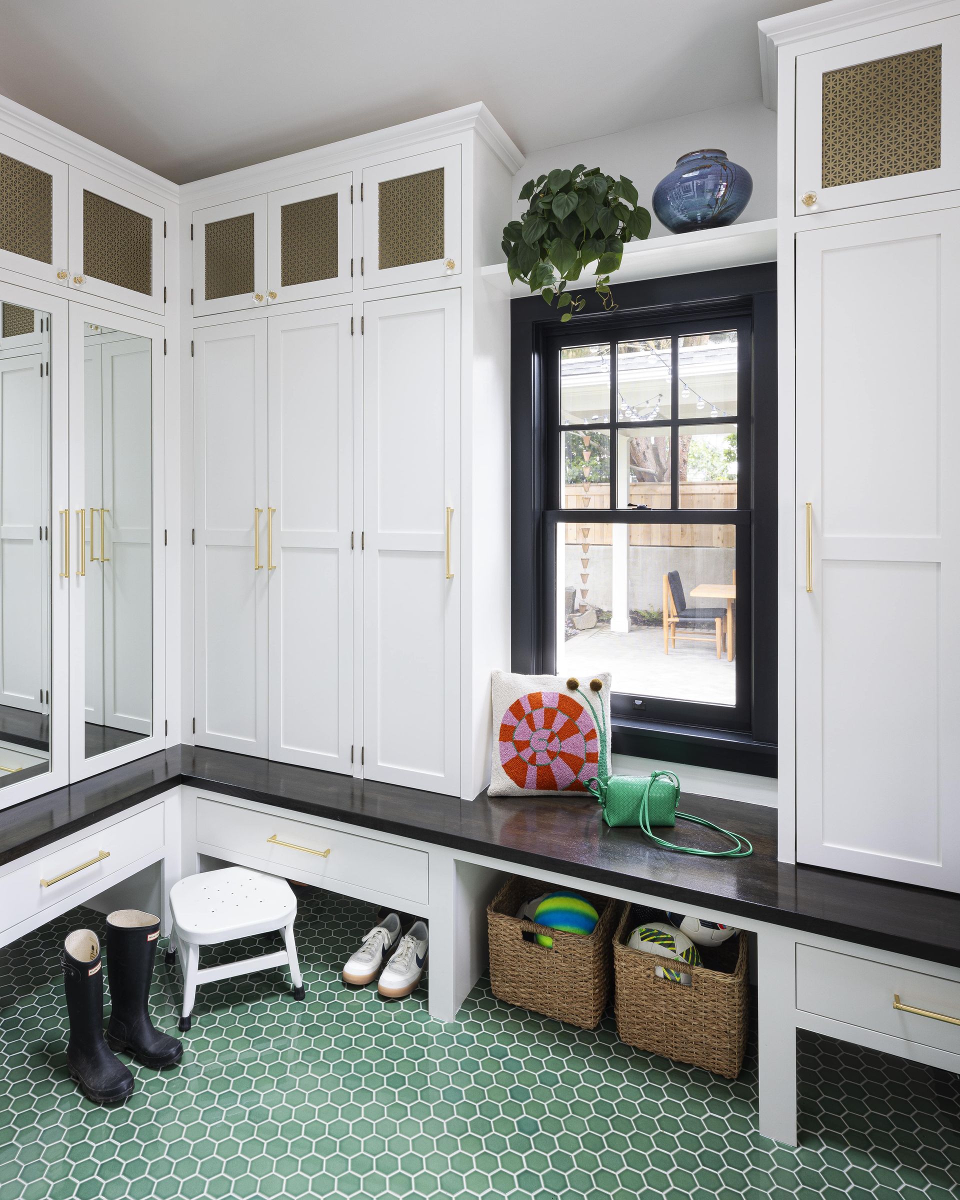 Looking at the corner of the new mudroom to show the plentiful storage and charm.