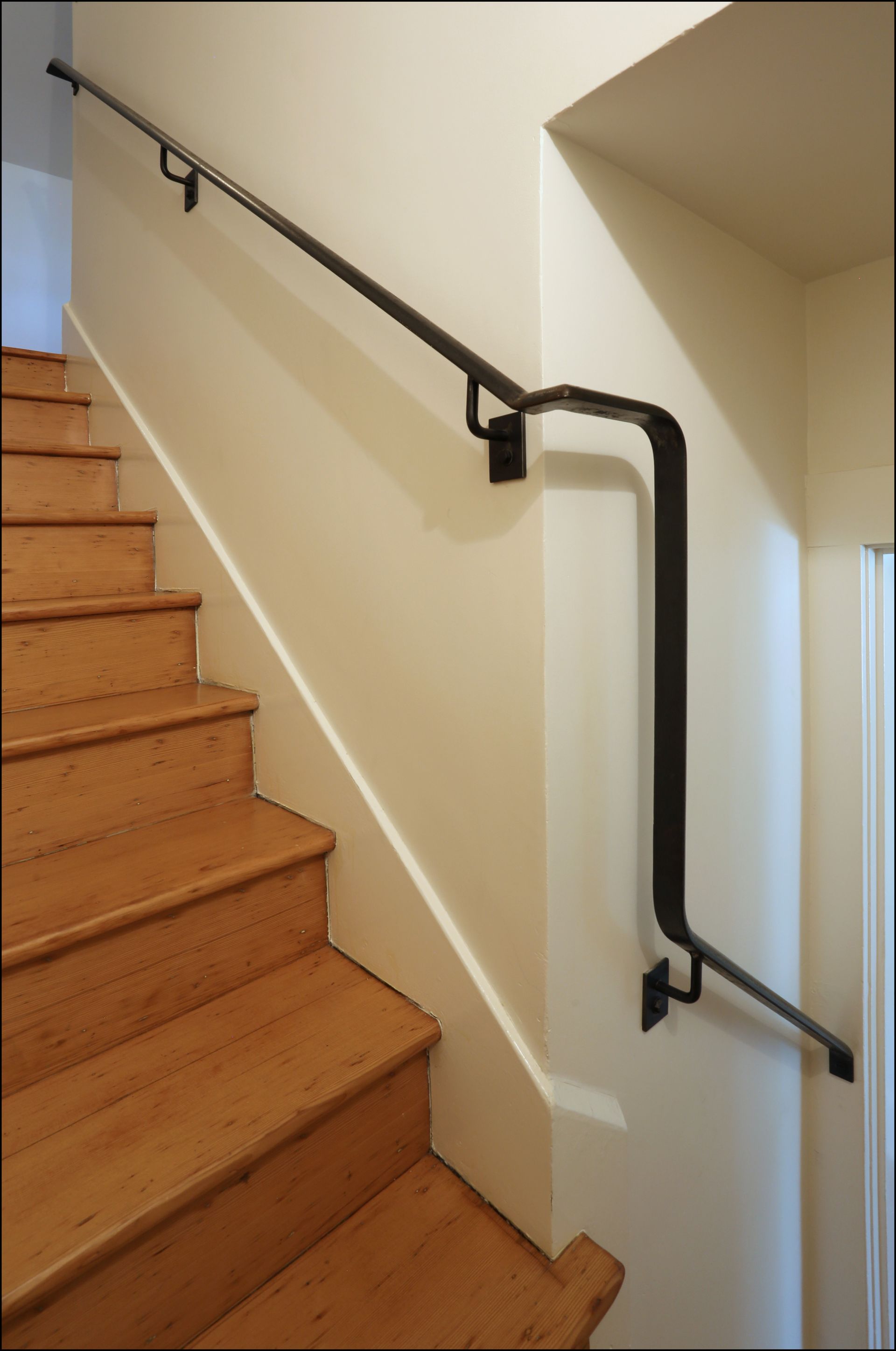 The basement stairwell has a new custom metal handrail. 