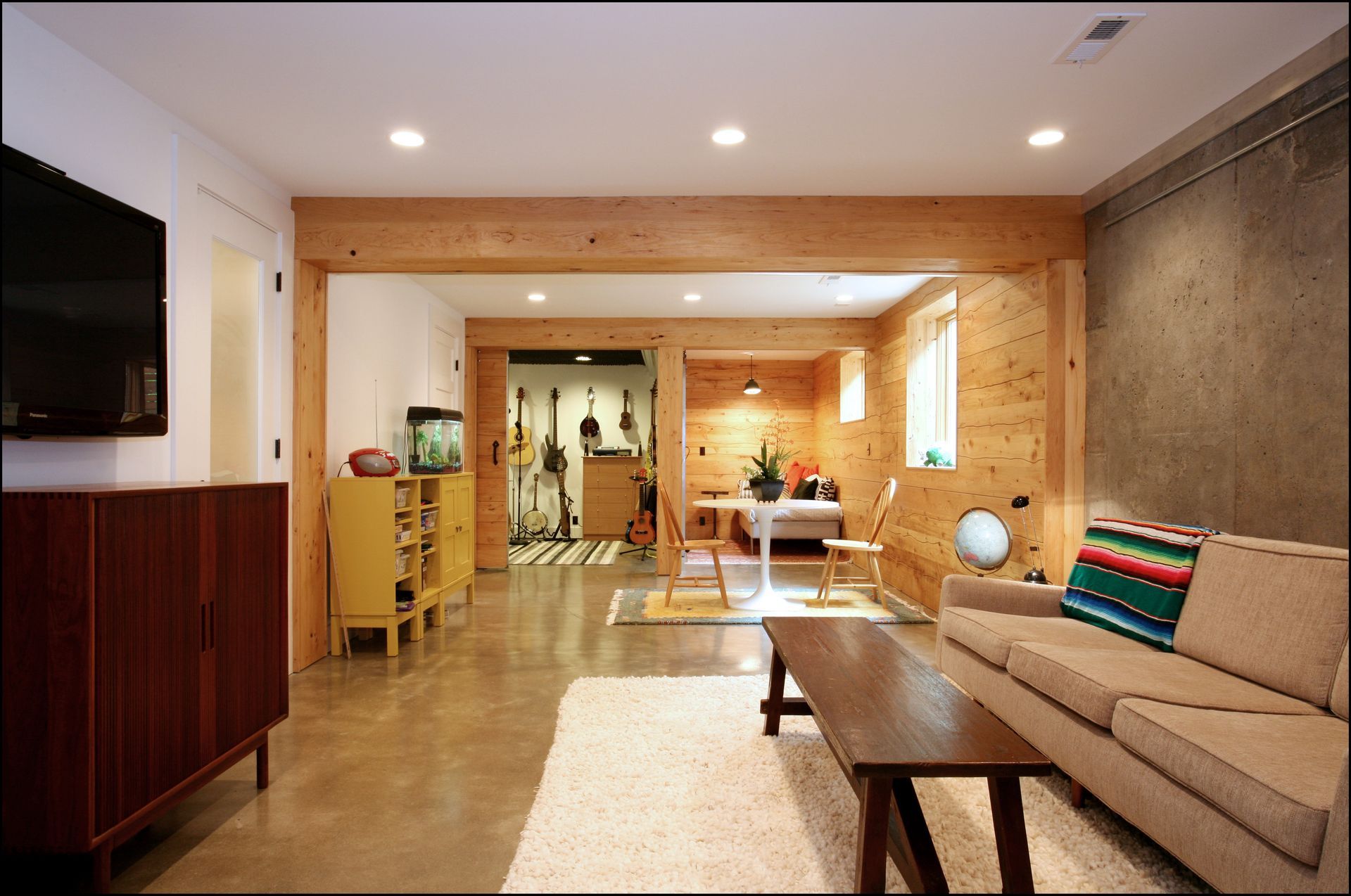 At the bottom of the basement stairs, you have a view of the new family room, music room and napping corner