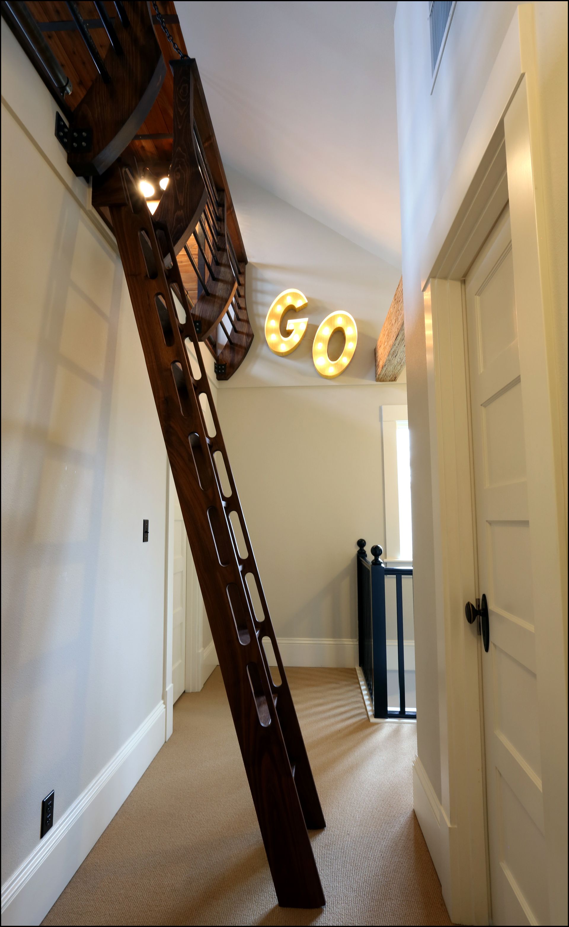 Looking at the ladder on the 2nd floor landing to the new loft, marquee sign on the wall in the background