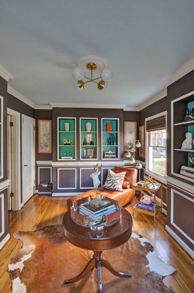 A living room with a round table and a chair