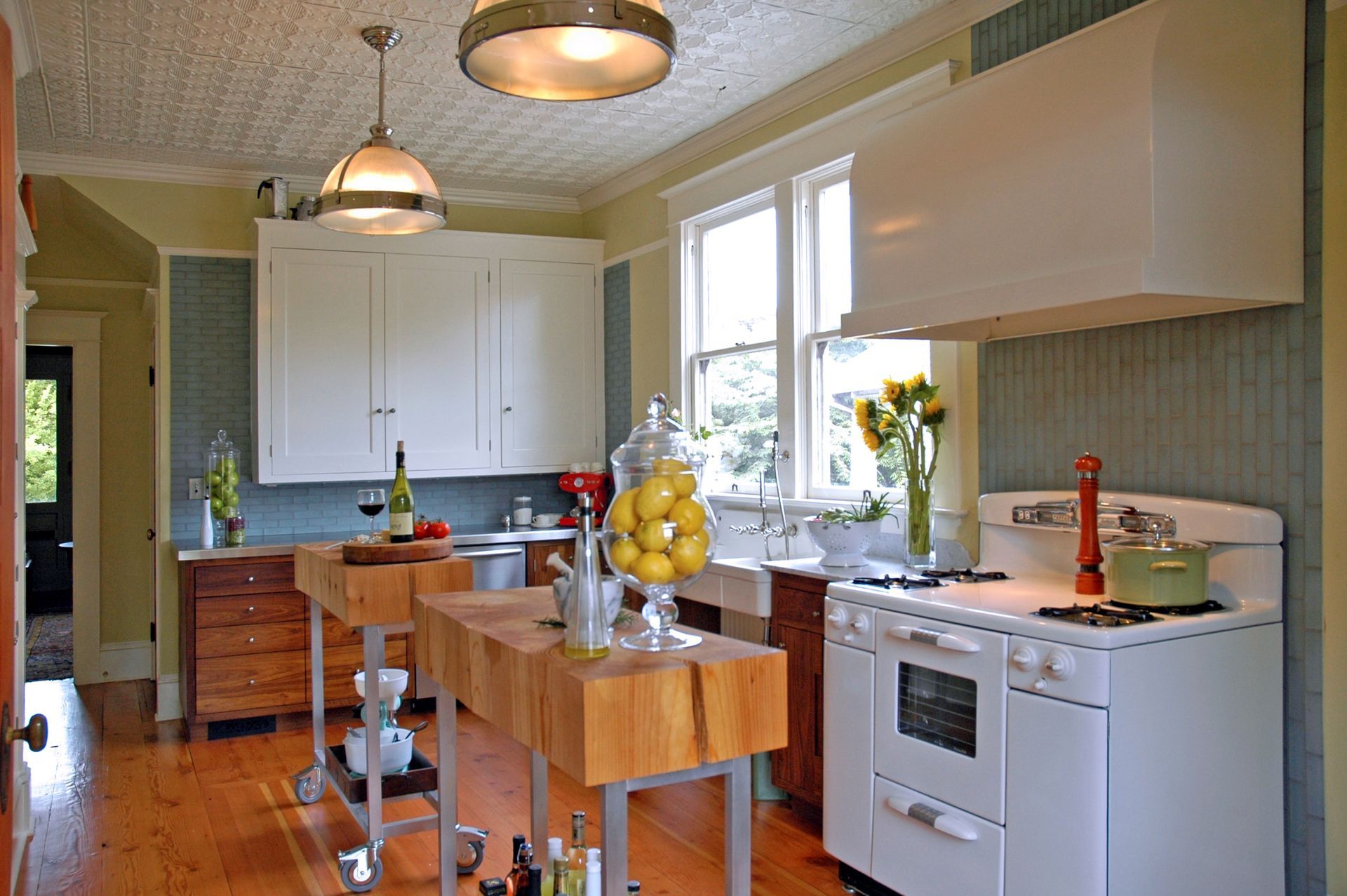 A kitchen with a white stove and a wooden island