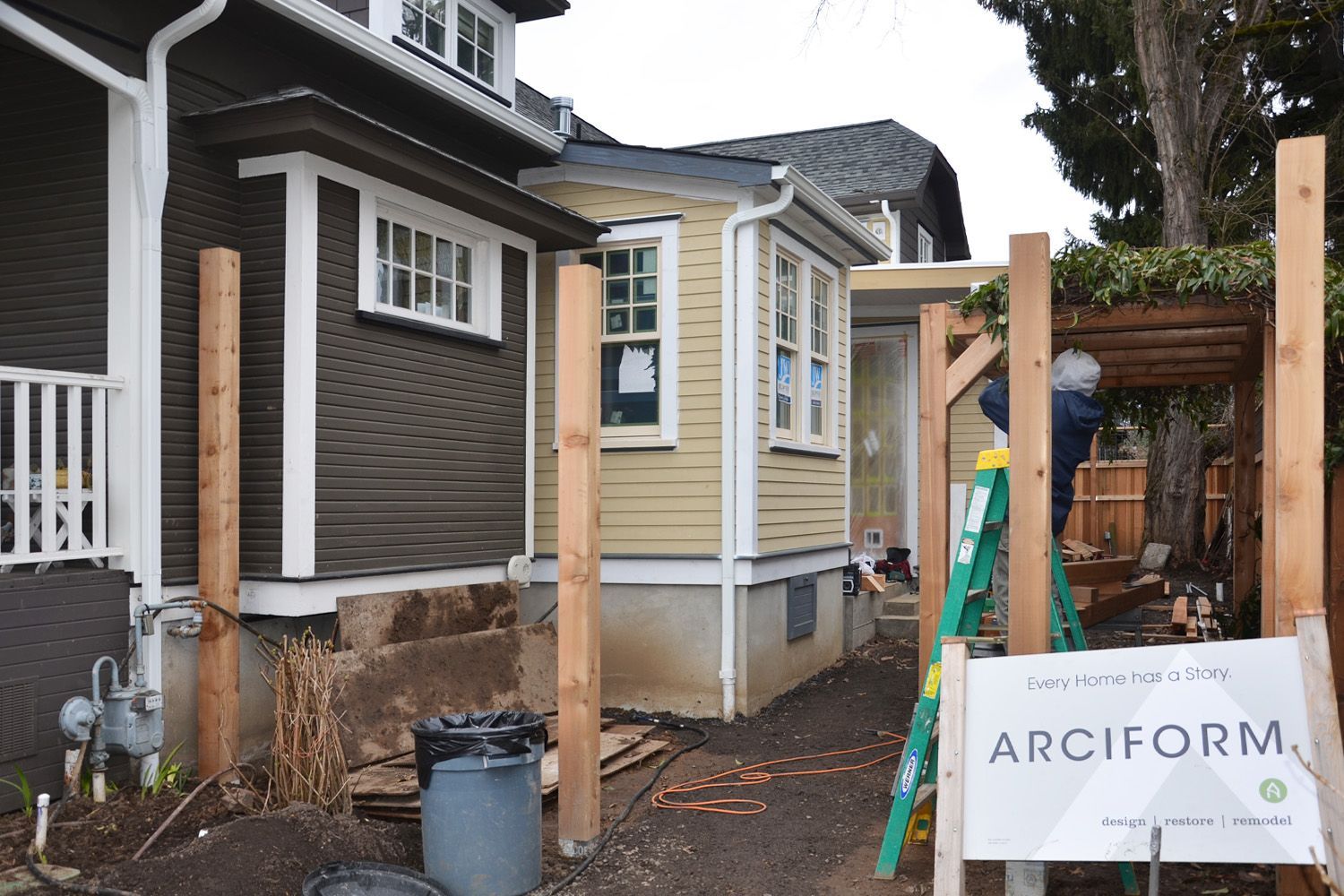 A charming, but too cozy, Sellwood bungalow was expanded in phases over several years. A breakfast room and mudroom addition appear in the middle ground, while the first two-story addition peaks out behind them. 