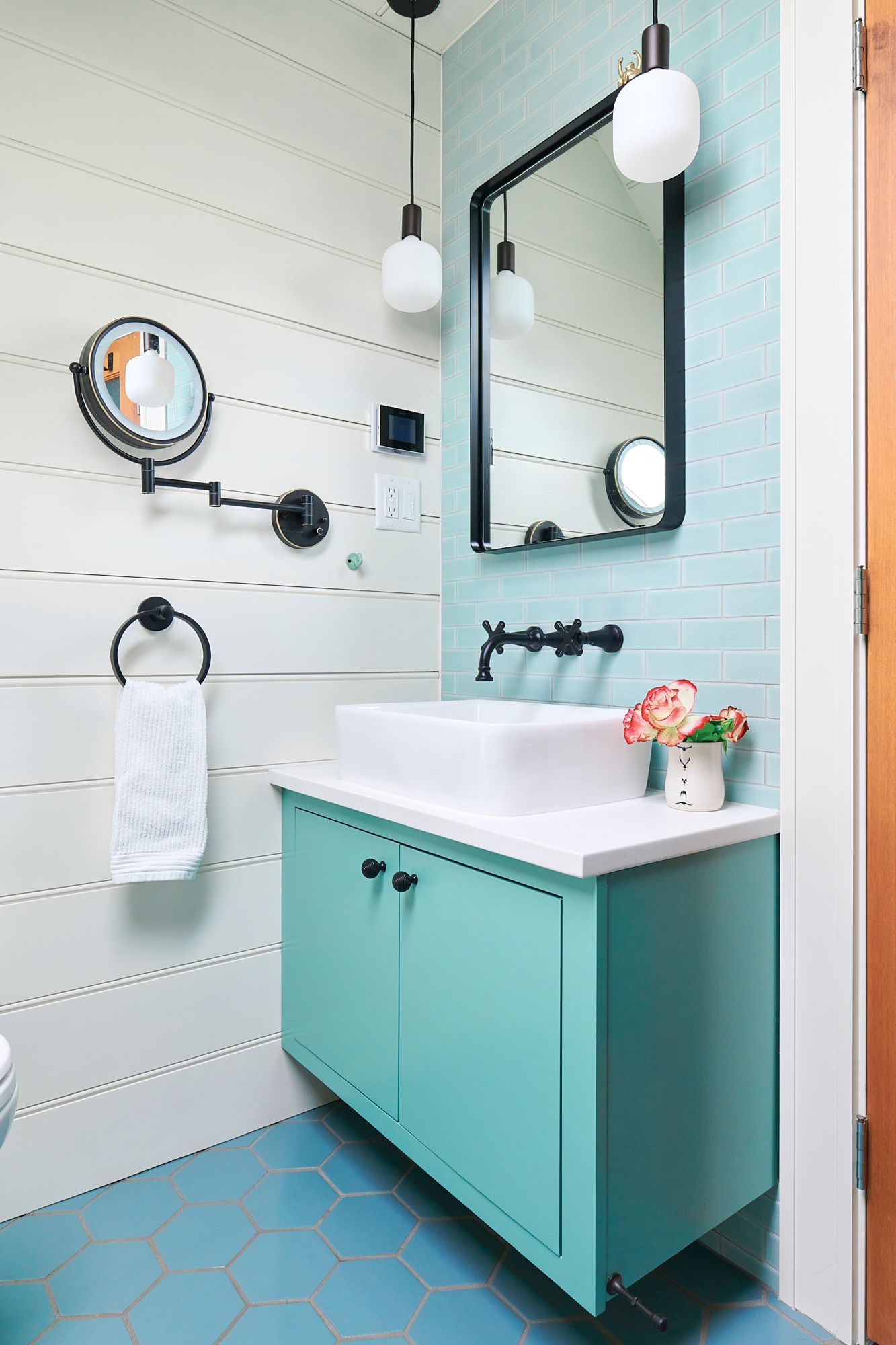 The 2nd floor WC was expanded to a full bath. The sink vanity is tucked into a corner but has plenty of space to get ready for the day.