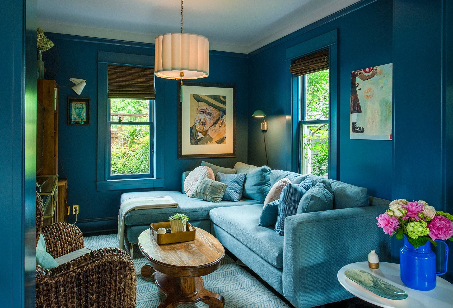The cozy back corner of the family room has a comfy couch and favorite artwork by the client's dad.