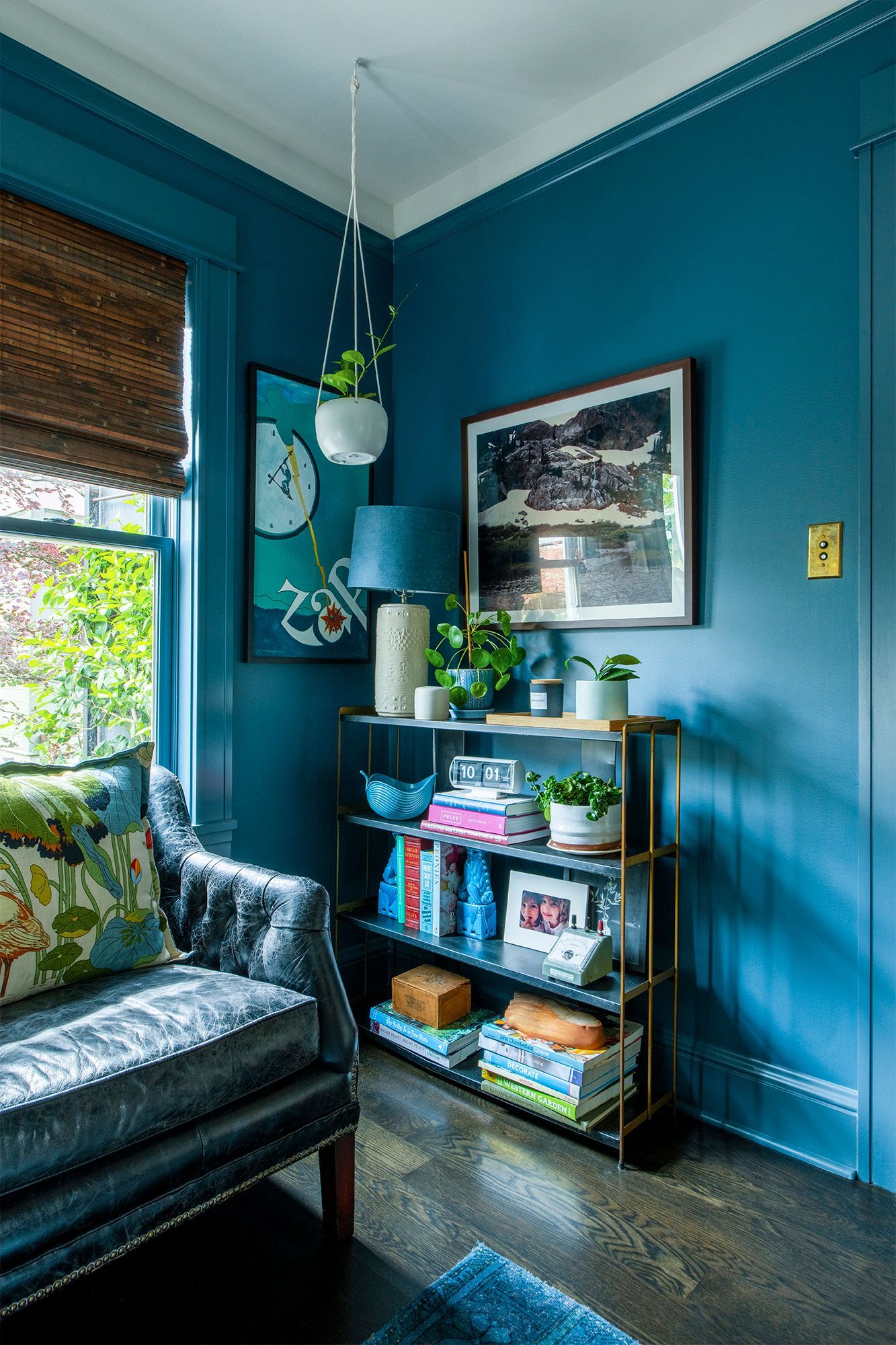 Opposite the fireplace, there's cozy furniture and a bookshelf stocked with favorite picks to enjoy on a stormy day