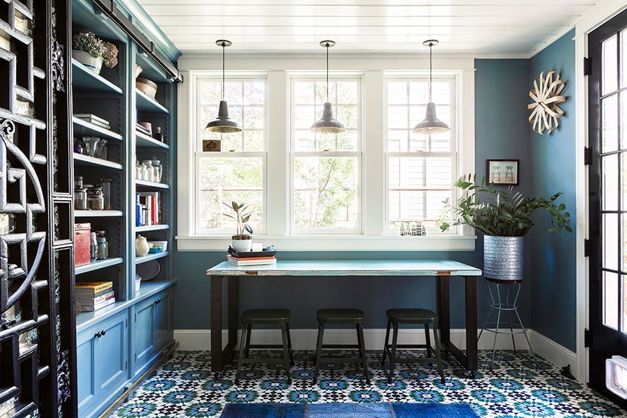The mudroom is more than an entryway - it has a craft table under a trio of windows with the built in cabinets just to the left.