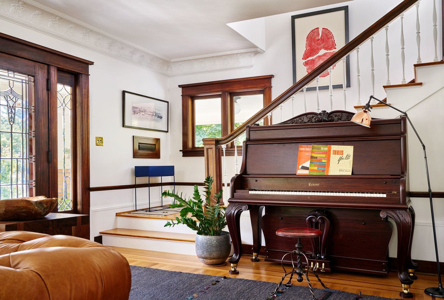 Inside the main door to the left, the main stairs curls up the outer wall to private spaces.