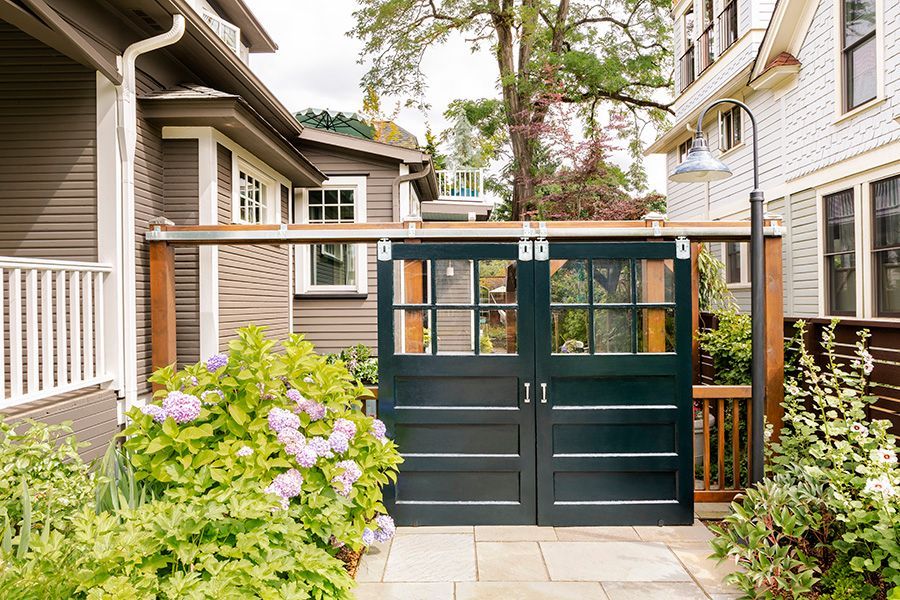 From the driveway, you can enter the outdoor living room through salvaged twin doors on barn door hardware.