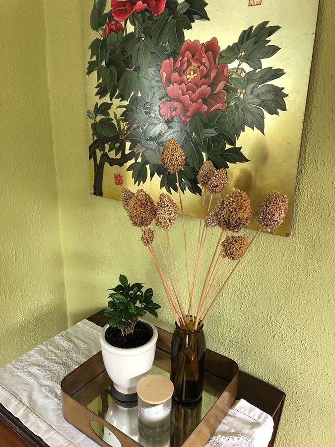 A painting Kerri purchased on the streets of Chengdu when she lived in China for a few years. “Peonies in China are a very special flower. They stand for riches and honor. It is a very special memory from that special time in my life,” says Kerri. The dried flowers are aliums from her garden.