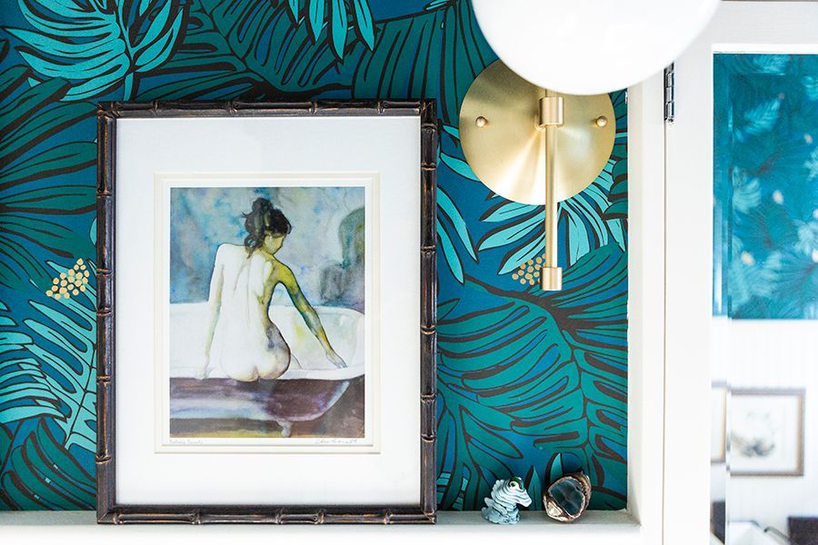 The main floor bath door has an antiqued mirror panel which leads you to the original bath, decked out in colors of the sea with crisp white trim.