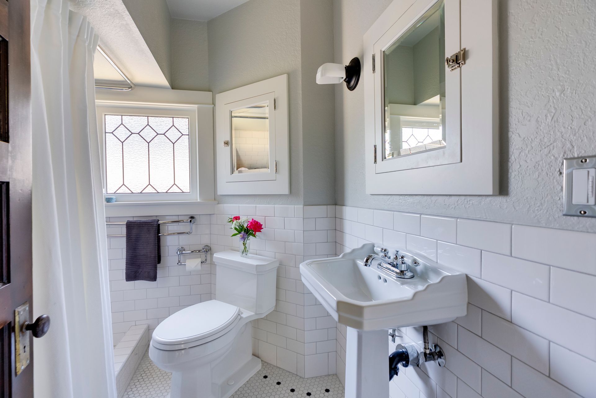 Working withing a very tight footprint, Arciform economically updated this 1915 bathroom using period-appropriate materials.