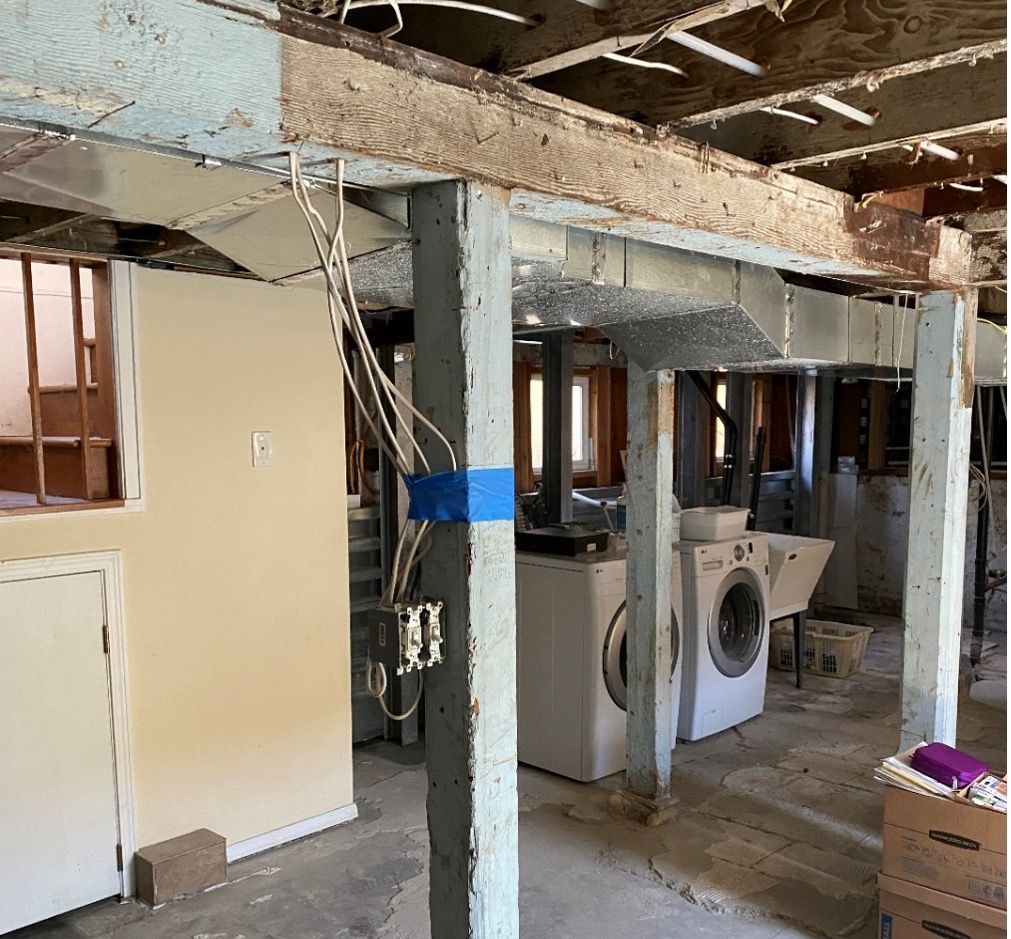 A basement with a washer and dryer in it