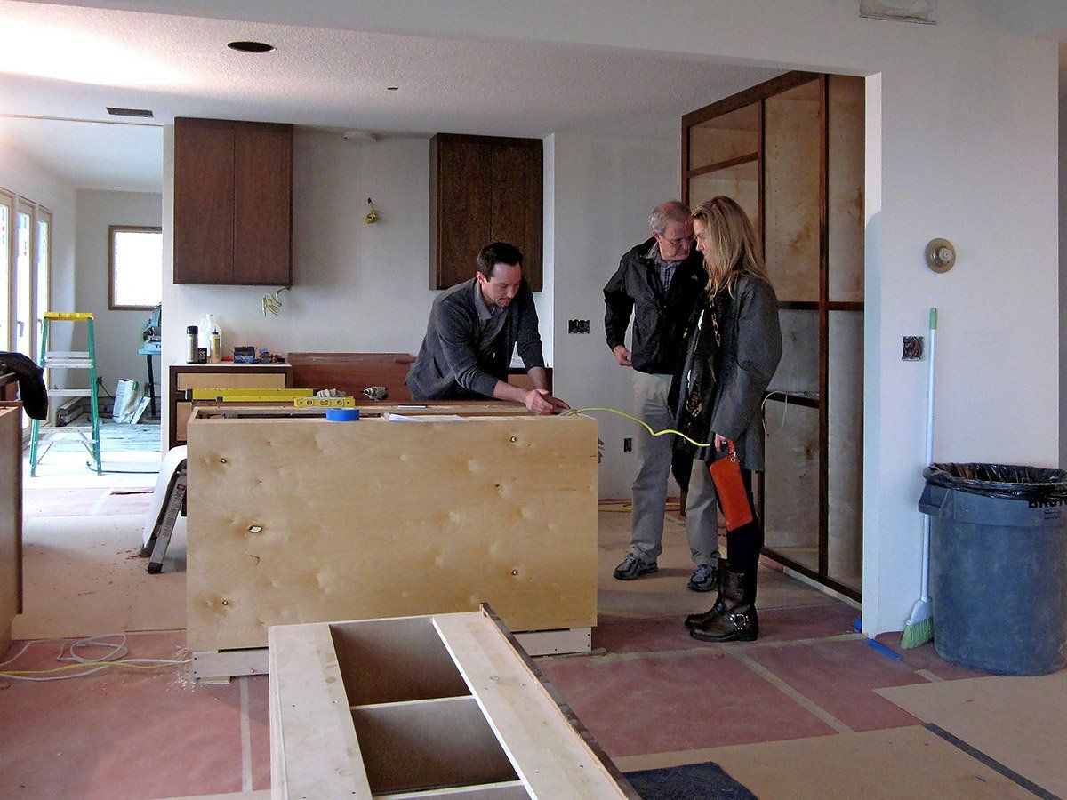 Project Manager, Client and Designer talk details after kitchen cabinet installation