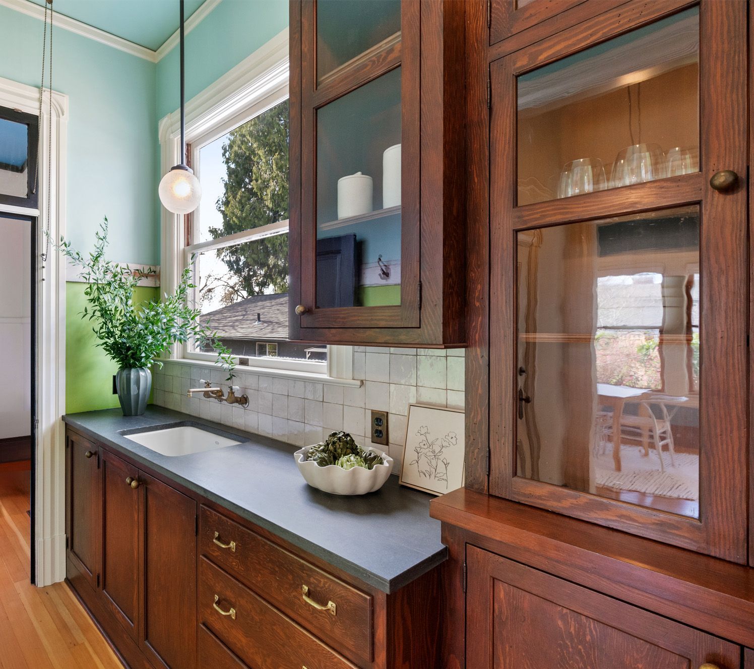 For a 19th century Portland Victorian, Arciform created a walk through pantry with new period-style cabinets and soapstone counters. 