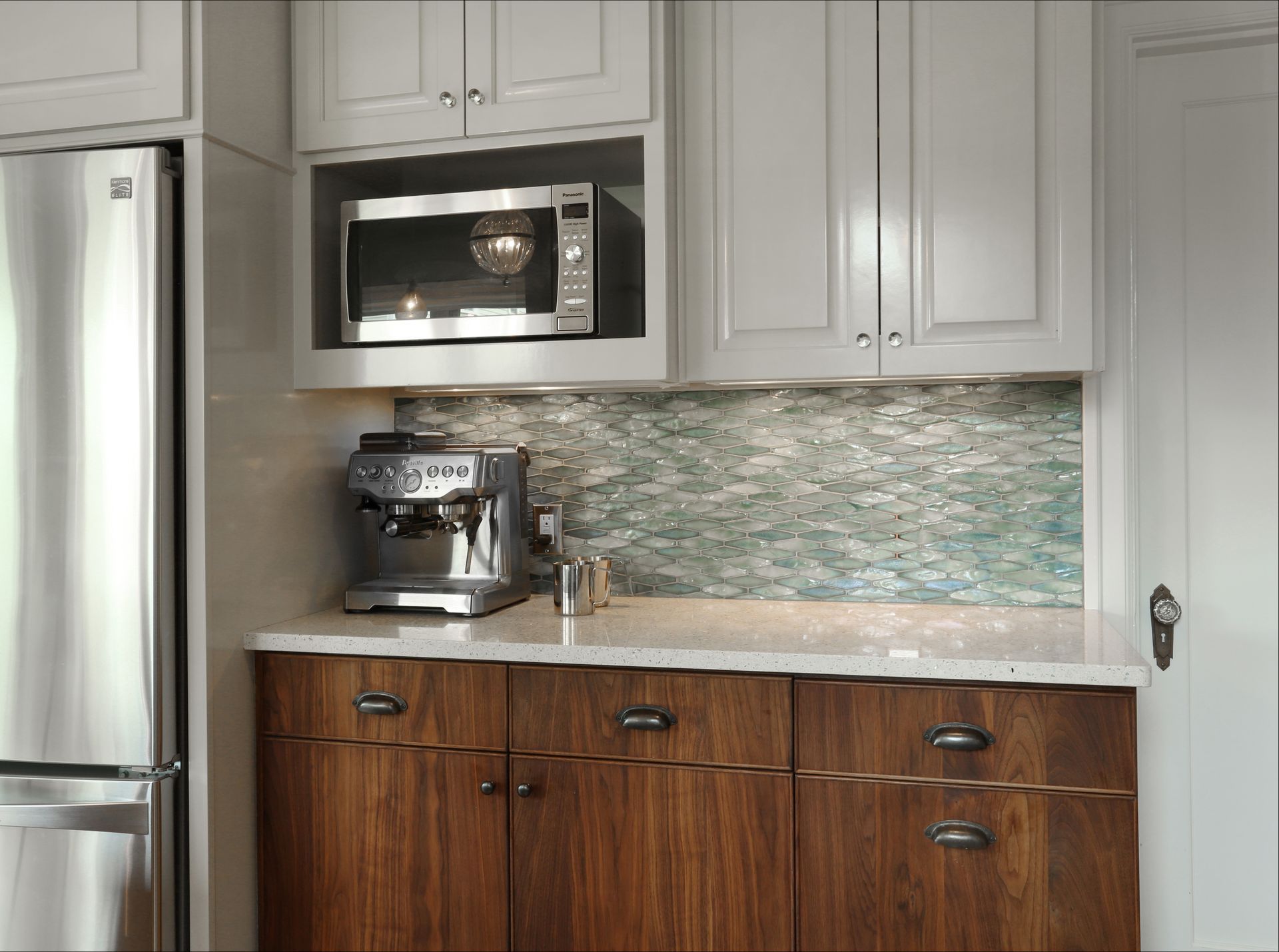 A corner of the kitchen with a niche for the microwave and a coffee station on the counter below
