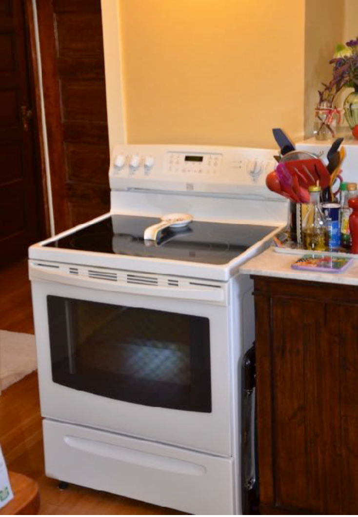 Before: the position of the range was not working well. Here, the range sits in front of the existing chimney. Jim is left-handed, so our team redesigned the layout, removing the chimney and sealing up the door in that corner, adding cabinetry and prep space to the left of the range