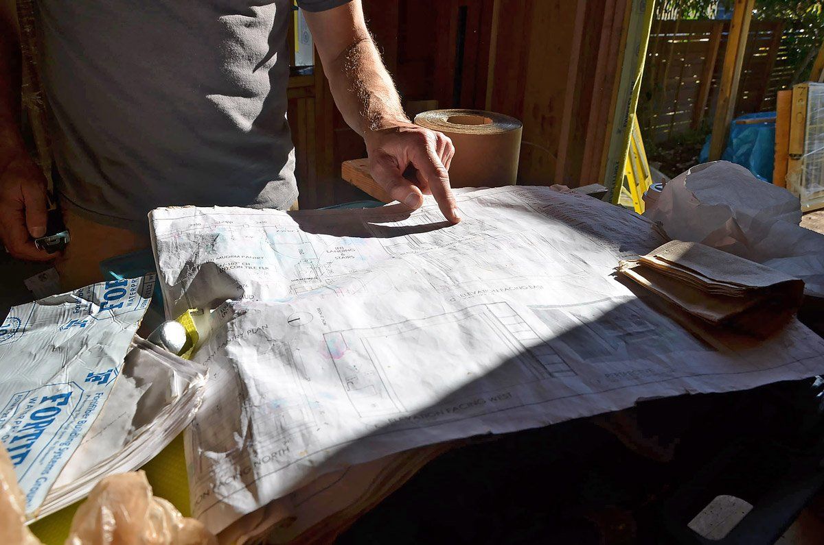 Site Lead checks details on his to-scale elevations during construction