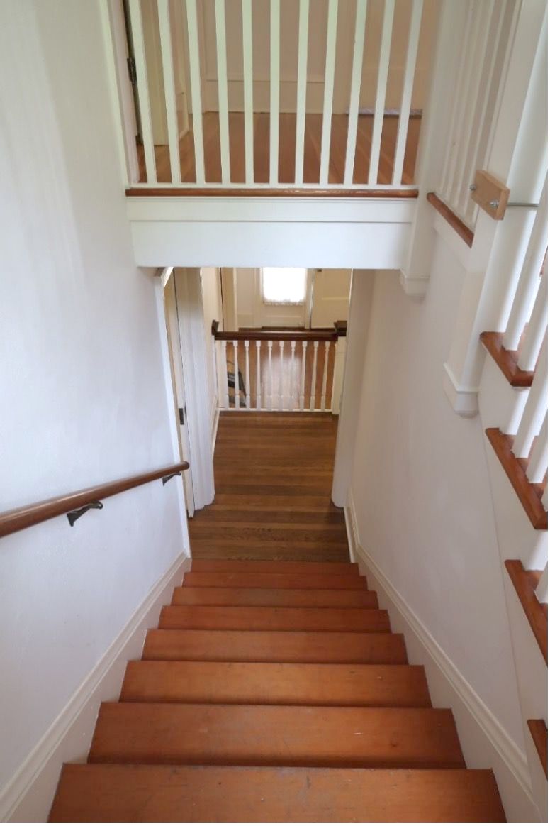 A wooden staircase leading up to the second floor of a house
