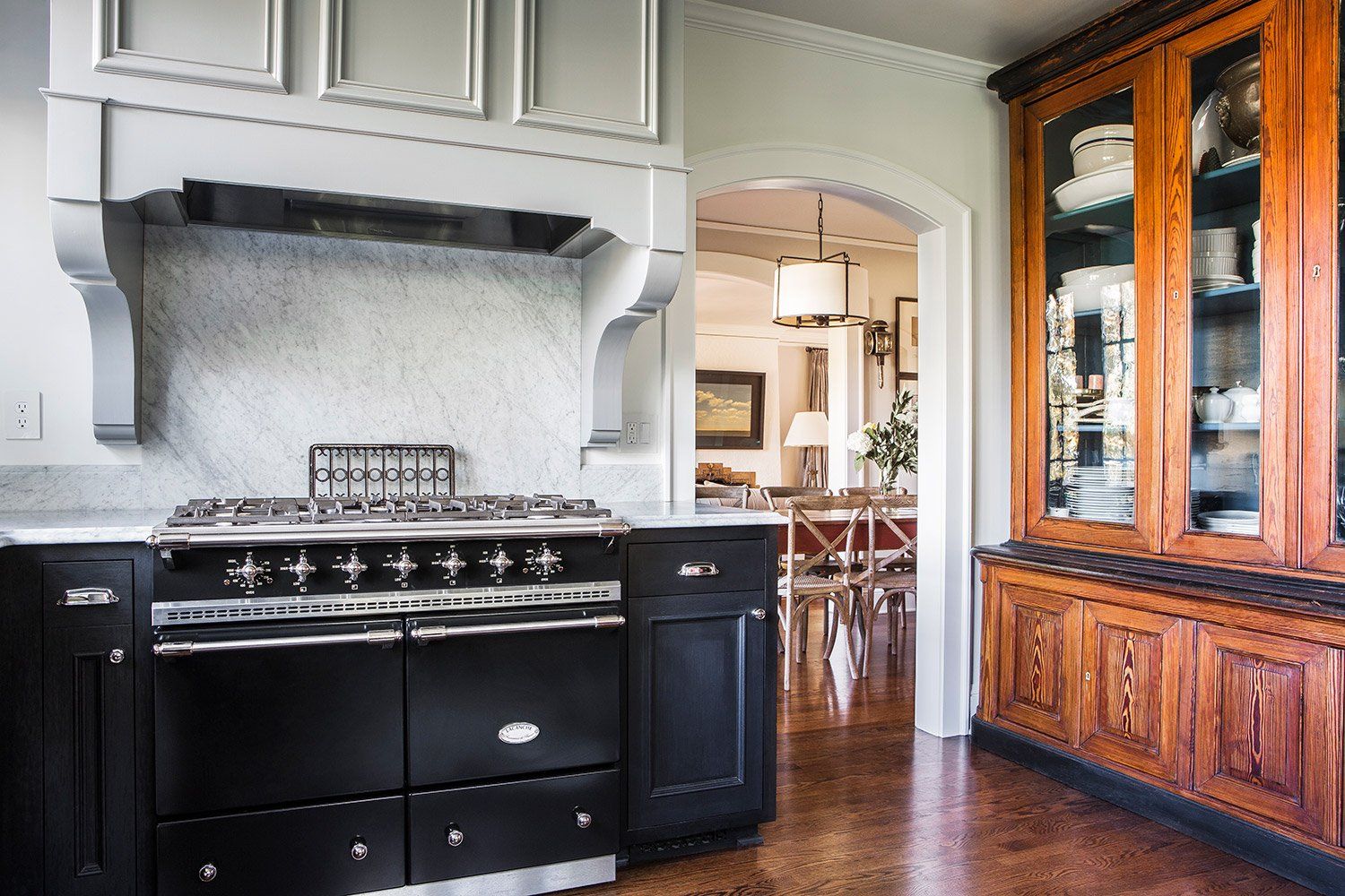 The black Lacanche range & pale gray custom hood are a focal point in the kitchen.
