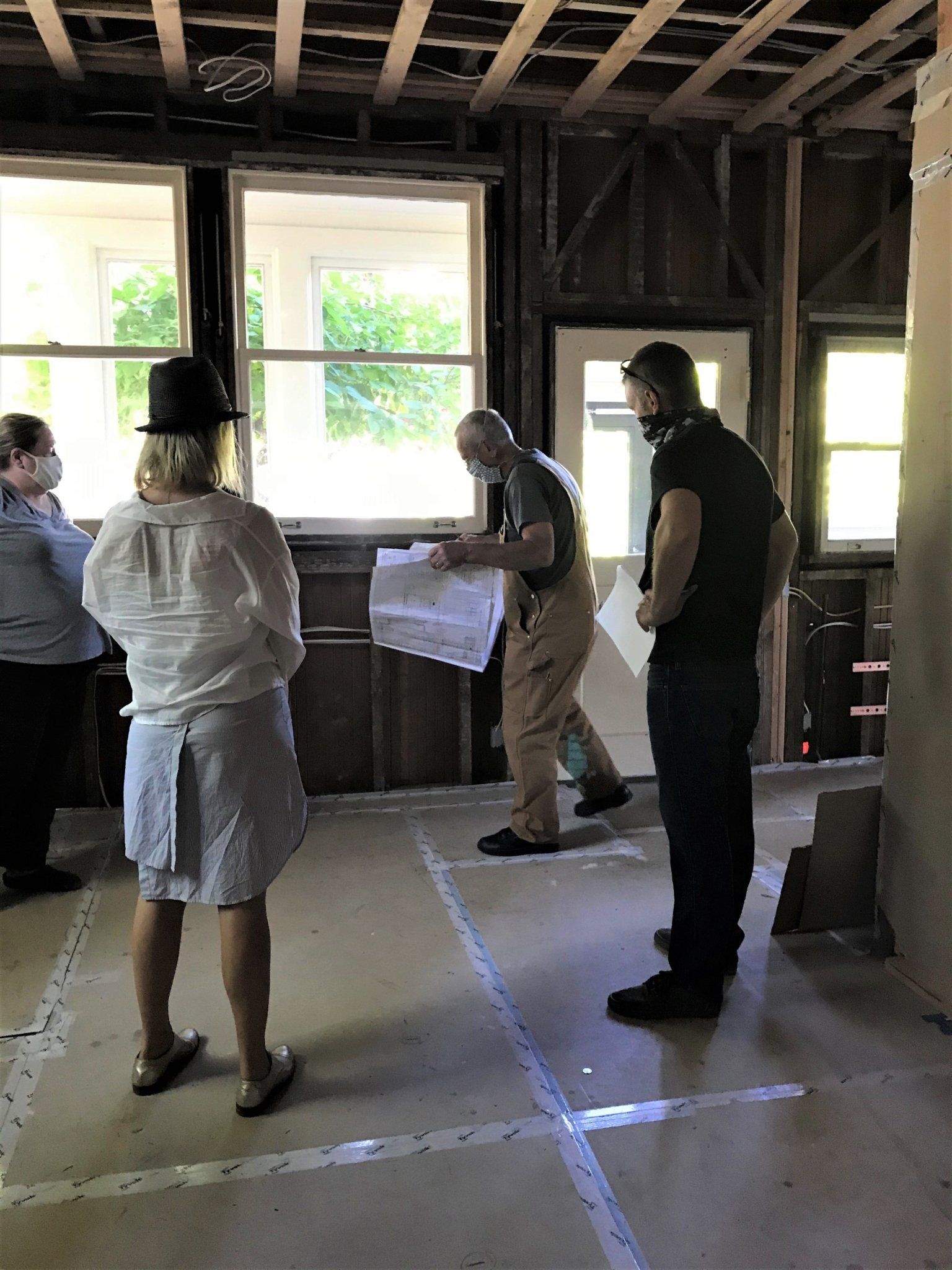 The design and build teams check a kitchen, pre-sheetrock.