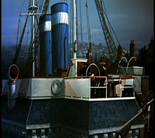 Blue-and-white ship smokestack and deck equipment on a steamboat against a cloudy sky
