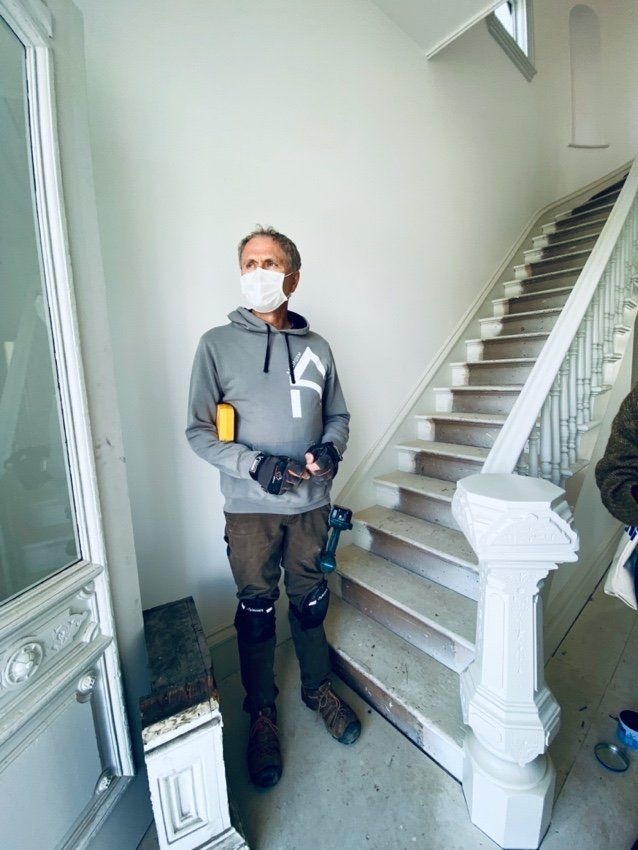 Roger Muller at the base of the ornate original staircase. Photo by Holly Cullom.