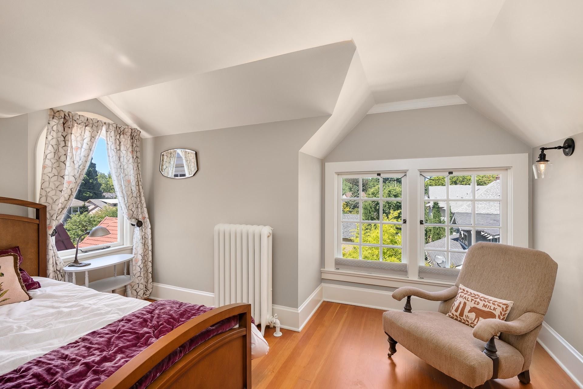 With multiple ceiling angles from crossing dormers, this recently restored attic bedroom, formerly a maid's room, has become a sought-after quest space in a historic Irvington home.
