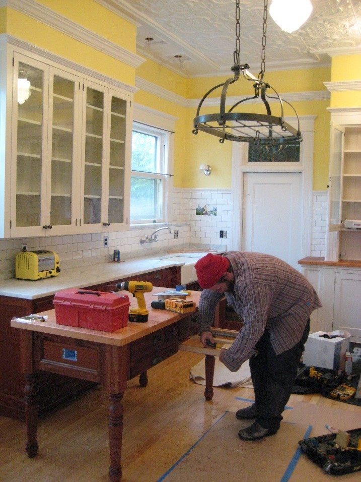 Lead carpenter Jamie Whittaker puts finishing touches on the custom island.