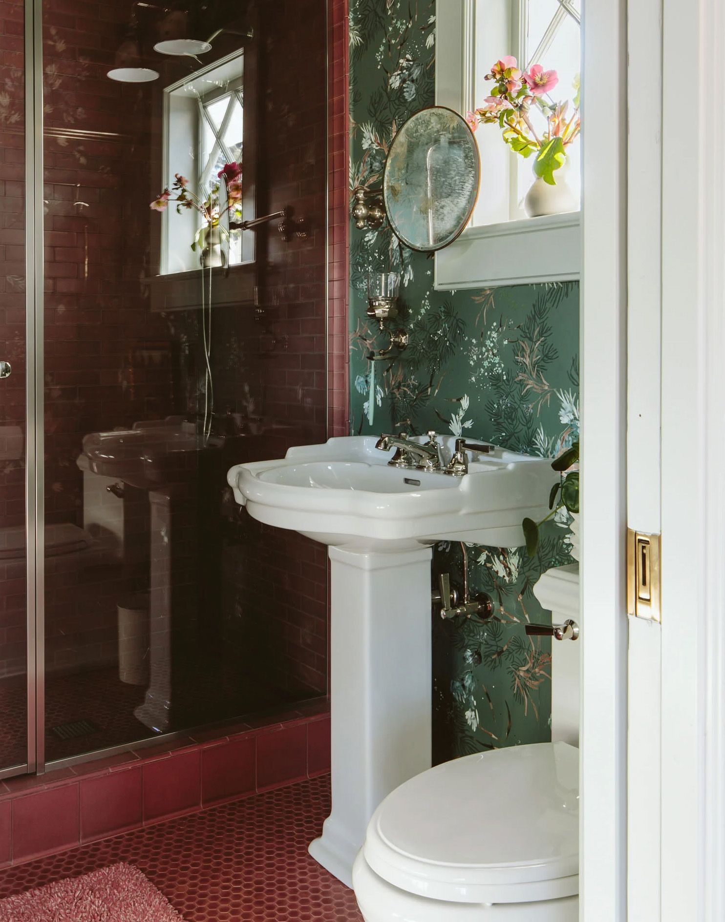 In this tiny farmhouse bathroom, a petite pedestal sink perfectly fits the narrow space. 