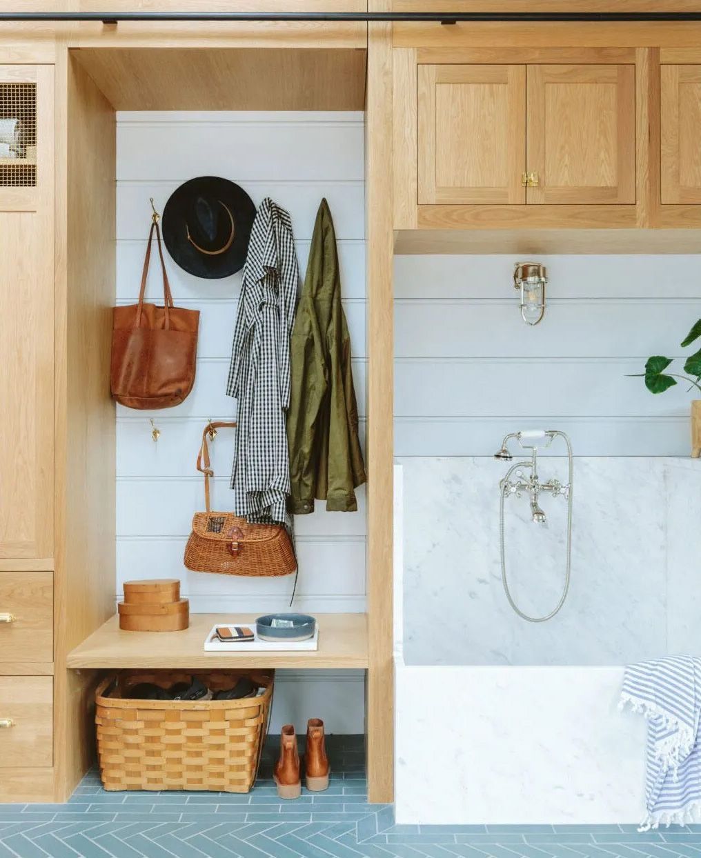 In Emily Henderson's well-equipped mudroom a mix of open cubbies (lined with hooks)  and concealed cupboards provide a wealth of storage options. 