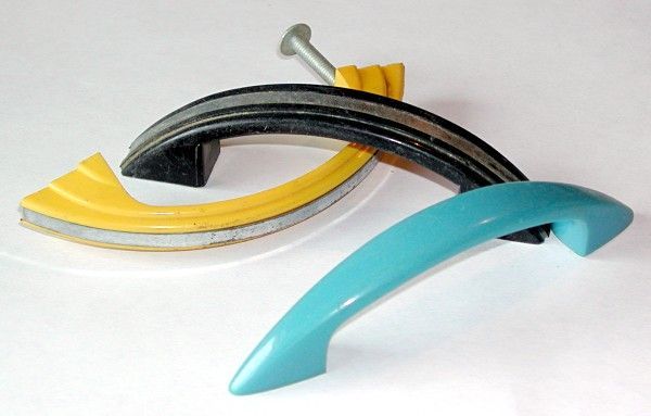 Assorted colorful cabinet handles and drawer pulls on a white background