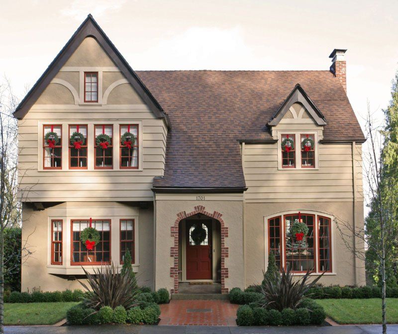 A house with christmas wreaths on the windows