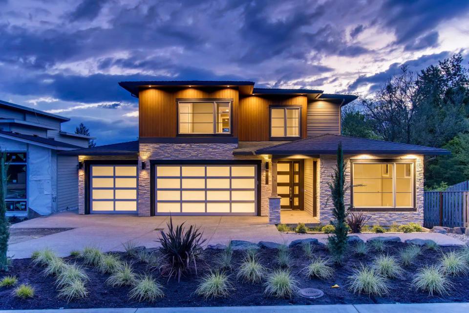 A large house with a lot of windows is lit up at night.