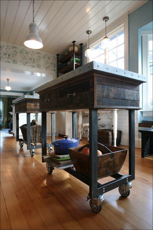Rolling kitchen island cart with wooden top and metal frame in a bright room