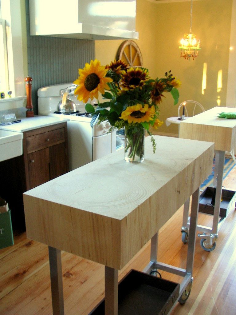 Kitchen island cart with flowers in a bright home kitchen