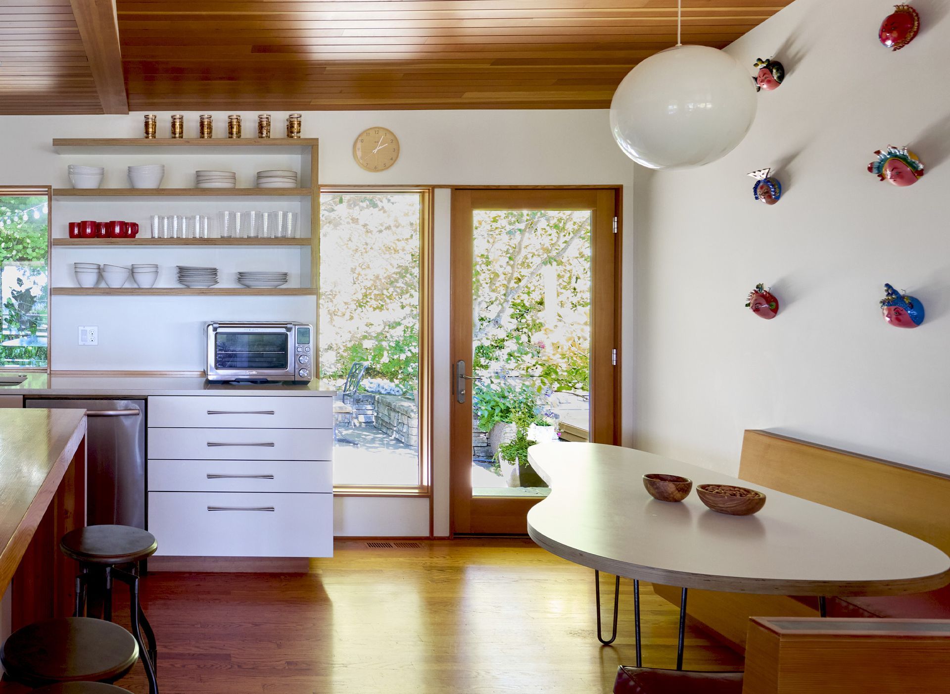 The kitchen connects to the back patio with a full lite door next to the banquette, offering a sweet view of the garden anytime of the day.