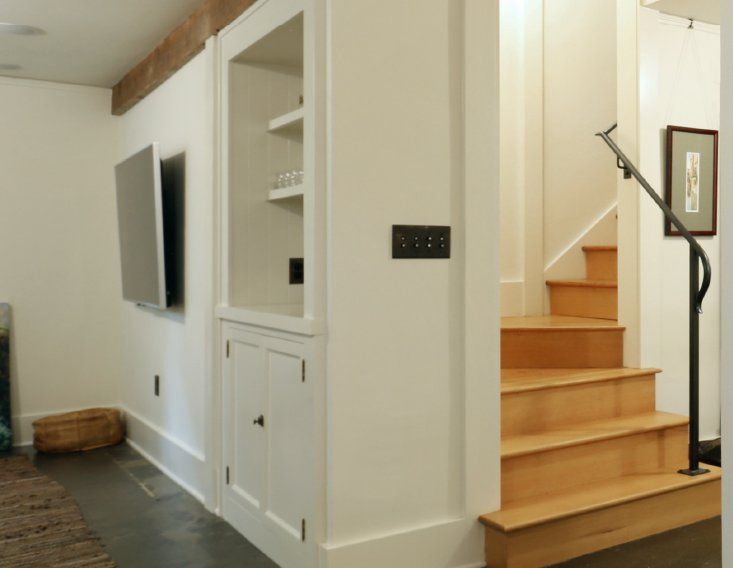 A hallway with stairs leading up to the second floor
