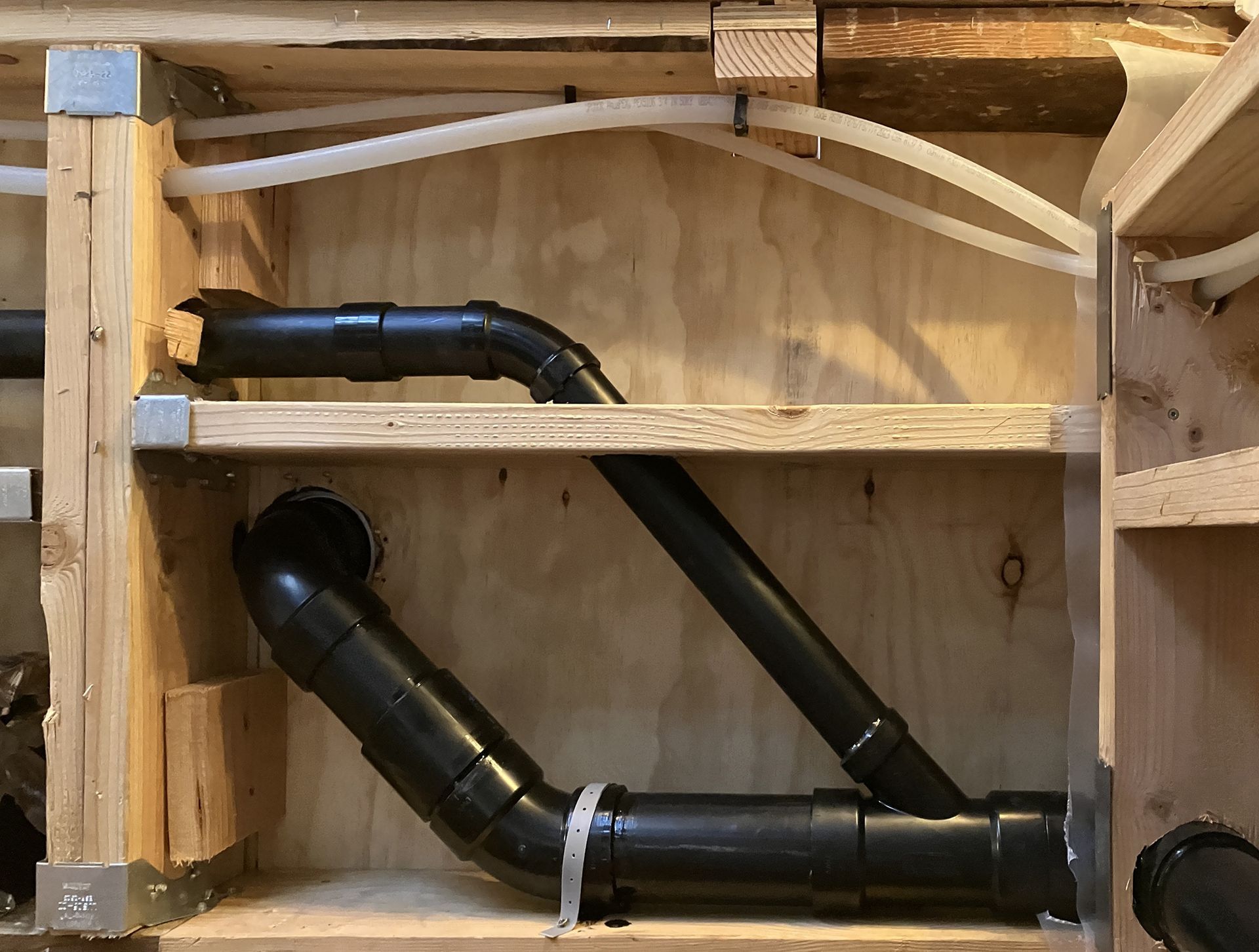 Looking up into the space once occupied by the service chimney in the above photo - we can see how there is now ample space for the shower and toilet drain pipes, keeping them above the ceiling in the room below. 