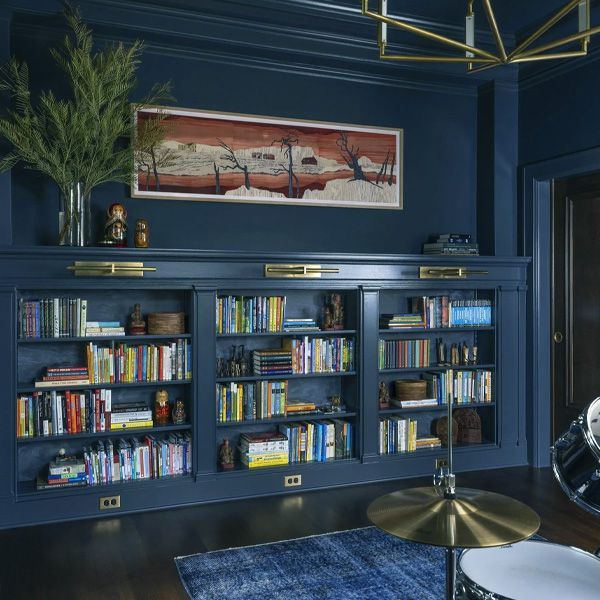 A living room with a brown leather couch and a coffee table.