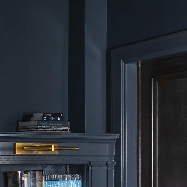 Walls, molding, and bookcases painted a dark blue color.
