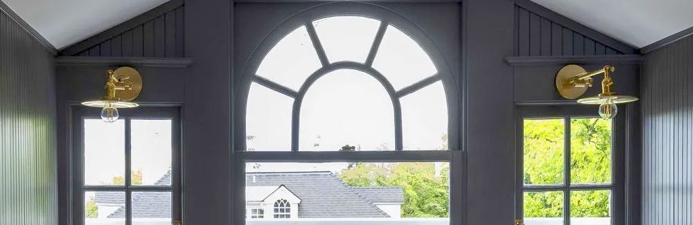 Three painted wood windows in a 1913 colonial style home.